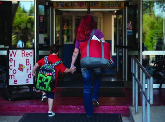 Students and parents walked into Monroe Elementary School in Oklahoma City on the morning of Aug. 11, 2022, the first day of school. (Whitney Bryen/Oklahoma Watch)