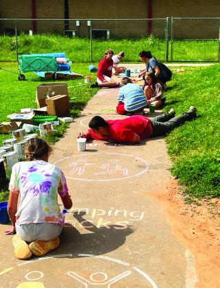 Sixth grade students and teachers at Maysville Elementary School painted outdoor activities on the sidewalks and concrete slabs of the school’s playground last week. Supplies for the Painted Playscape project were funded by a TSET grant awarded to Maysville Schools this year. School officials say the project is just one of many unique opportunities the grant has provided students. Courtesy photo