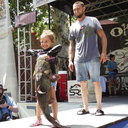 Five-year-old Kennedy Dalton and her dad, Jesse, of Lawton, weighed in an 18.46-pound catfish during last year's Okie Noodling Tournament.