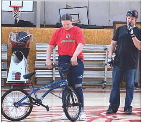Whitebead eighth-grader Madison Groves, assisted in demonstrating how to do a bike safety check before riding during Whitebead’s show Wednesday.