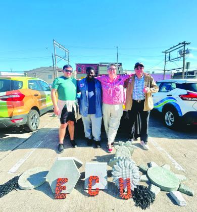 The ECU Glass Recycling team at their booth at the Ada's Farmers Market, showcasing their unique concrete pavers made from recycled glass.