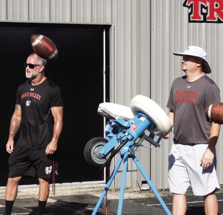 Pauls Valley assistant football coach Wakley Bergner (right) demonstrates Pauls Valley’s new JUGS machine during practice at Thompson Field Tuesday morning. The automated passing and kicking machine can deliver up to 600 passes or kicks an hour, allowing players to get in plenty of repetitions as they develop their skills. News Star photo by Chris Mackey