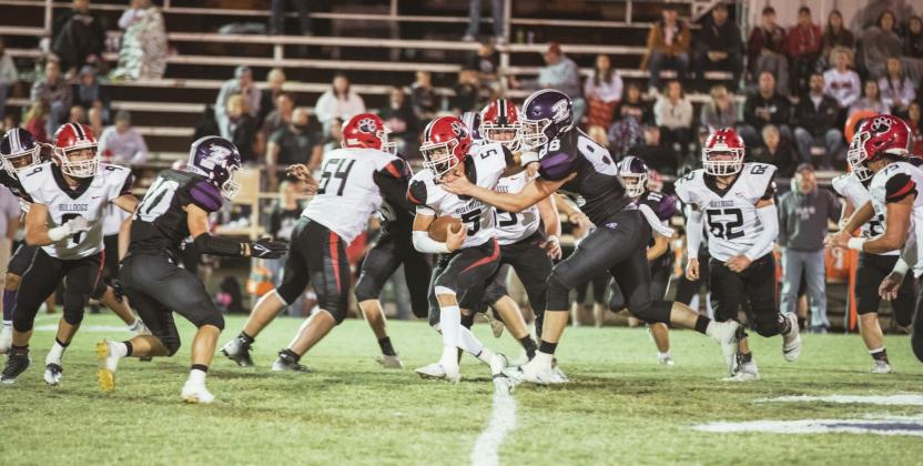 Stratford’s Hunter Morton tries to run through the Elmore City-Pernell defensive line in last week’s game. Stratford’s defense helped the Bulldogs pull out a 34-6 win. Photo by Jake Faucett
