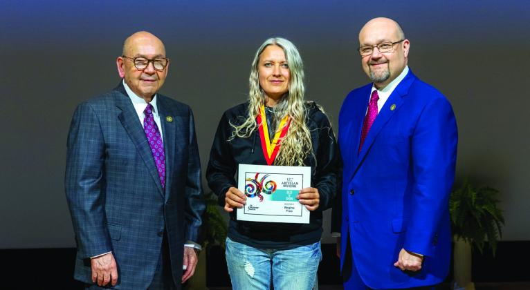 Chickasaw Nation Governor Bill Anoatubby and Lt. Governor Chris Anoatubby present Chickasaw artist Regina Free Best of Show for her work “Osi” (eagle) during the Artesian Arts Festival.