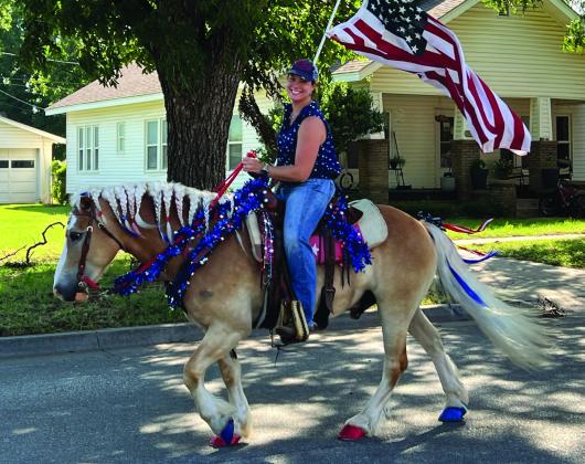 Ashlee Eddings, of Wayne, and her horse were all decked out in red, white and blue for Pauls Valley‘s Heritage Days Rodeo Parade Saturday. Garvin County’s rodeo action will continue July 10-11 as the Wynnewood Round-Up Club hosts its 68th annual Rodeo. News Star photo by Suzanne Mackey