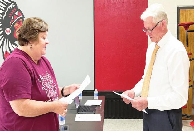 Belinda Hunt was sworn in and took her seat on the Whitebead Board of Education Monday. The oath of office was administered by Whitebead Board of Education member Ed Tillery (right). Hunt was elected to the office April 5.