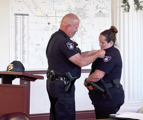 Pauls Valley Police Chief Derrick Jolley presented officer Brittany McGehee with new collar brass signifying her promotion to patrol sergeant during Pauls Valley’s City Council meeting Tuesday evening. Sgt. McGehee has been employed by the Pauls Valley Police Department since 2008. News Star photo by Suzanne Mackey