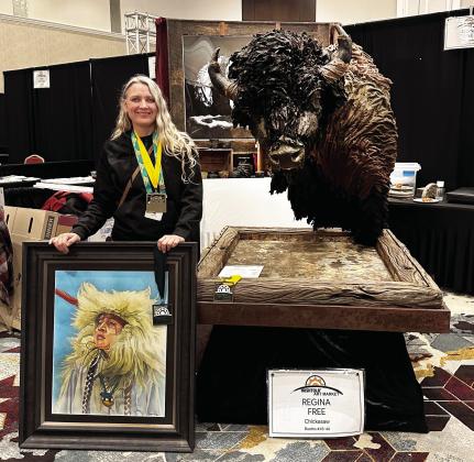 Chickasaw artist Regina Free poses with Windswept and “Hopi Dancer” at Hushtola Art Market. Windswept was judged Best of Show and “Hopi Dancer” was awarded Best of 2D during competition Dec. 1415 at WinStar World Casino and Resort near Thackerville, Oklahoma. Free lives in Newkirk, Oklahoma, about three miles south of the Kansas-Oklahoma border.
