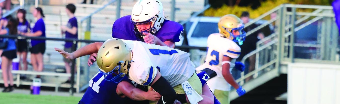 The Elmore City-Pernell’s defense of Owen McConnell (#11), Carston Lauderdale (#44) and Devin Stanley (#52) force a Central Marlow fumble during Thursday action at Wheeler Field. Photo by Mike Arie