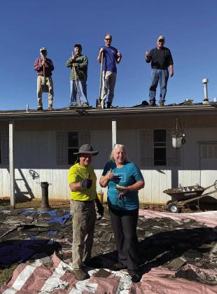 Ed Bevers, front left, leads a team of volunteers during a roofing project for Recovering Oklahomans After Disasters. Bevers was recently named chairman of the ROAD board of directors. Courtesy photo