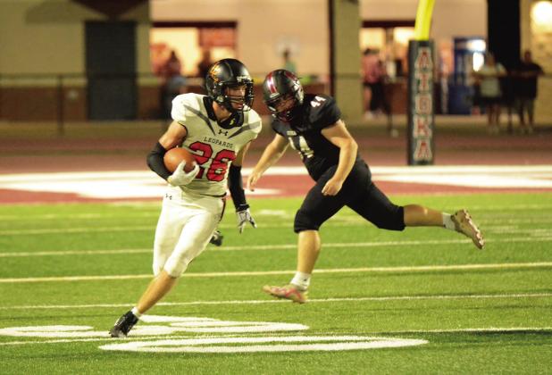 Lindsay’s Crew Flood runs away from the Atoka defender during last week’s 62-24 win at Atoka. News Star photo by Denny Park