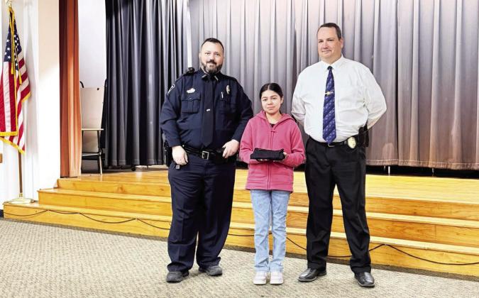 PVPD School Resource Officer Heath Chappell (left) and PV Police Chief Don May pose here with one of the more than 100 Pauls Valley sixth-graders who recently graduated from a 10-week DARE program at Pauls Valley Intermediate School. As part of the program students learned about coping and stress management skills, how to make better decisions, anger management, how to navigate bullying and about the negative health impacts of alcohol and tobacco use.