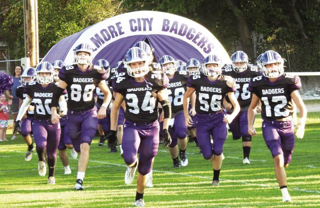 Elmore City-Pernell Badgers #34 Senior Will Balentine and #12 Junior Caleby Lauderdale lead the team onto Wheeler Field for the season opening game against the OKC Patriots. The Badgers lost a tough game against the Patriots 21-12. News Star photo by Chris Mackey