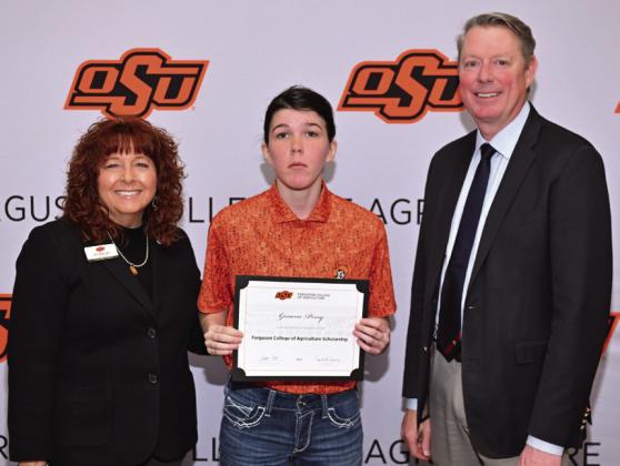 Cynda Clary, associate dean for academic programs, and Jayson Lusk, dean for the Ferguson College of Agriculture, present Geneva Perry with a scholarship