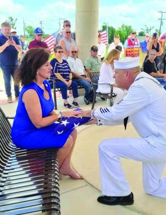 Rep. Tammy Townley receiving the ceremonial flag. Courtesy photo