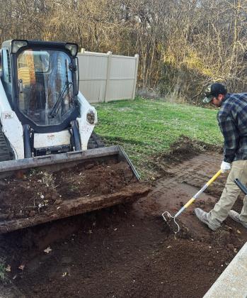 Austin Stephens of Dirt Work Outfitters preps the site of a new handicap accessible sidewalk that will connect a playground area at Pauls Valley Terrace apartments to the existing sidewalks near the apartment units. Photo courtesy of Amber Odom-Sullivan
