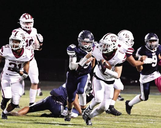 Wynnewood’s #0 Aydrian Knighten, #21 Brylan Williams and #55 Adrian Hernandez plow through the Bulldog defense during the Savages’ 10-0 win over Minco last Friday. The Savages play Okemah at home this week. Okemah is 1-4 on the season and lost 24-0 to Frederick last week. Kickoff is scheduled for 7 p.m. News Star photo by Don Coffey