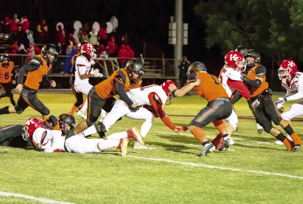 The Lindsay Leopard defense swarms the Kingston running back during last week's first round playoff win over the Redskins, 49-27. News Star photo by Kristy Schrader