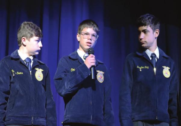 Stratford FFA member Braxton Bear gives a word of what a true veteran is, while Carson Owens and Braylin King look on. Photo courtesy of Halle Pullen