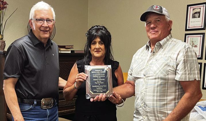 Stratford Mayor Johnny Mann (right) presented Rick and Lisa Griffin (left) with a plaque of appreciation from Stratford’s Town Board Tuesday evening for their dedication and service to the community.