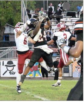 Wynnewood’s #6 Braylon Pierce and #2 Jett Anderson surround the Wewoka Tiger receiver as he makes the first down catch. Photo by Don Coffey