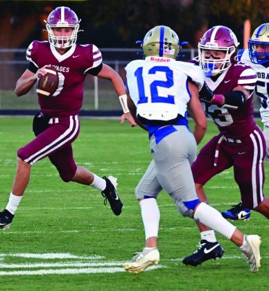 Wynnewood’s Phoenix Delaplain and Briar Davenport work around the Hobart defensive back in the Savages 56-14 win last Friday. News Star photo by Don Coffey