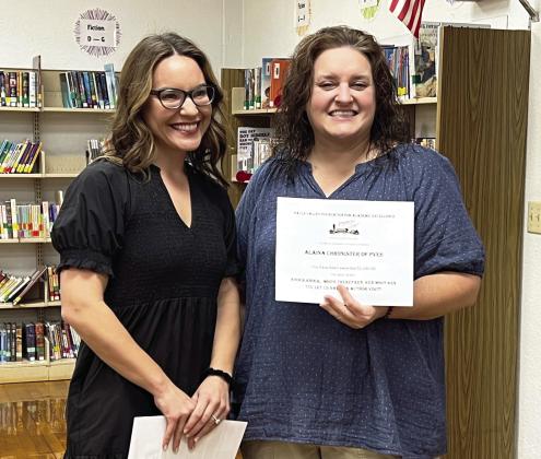 Pauls Valley educator Alaina Chronister (right) was one of nearly 30 certified teachers from the Pauls Valley and Whitebead school districts who received 'Grants for Teachers' awards from the Pauls Valley Foundation for Academic Excellence Tuesday. Chronister was awarded three grants which will be used for materials and projects at Pauls Valley Elementary and Intermediate Schools. PVFAE board member Camille Milligan (left) presented Chronister with the grant awards.