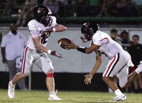 Pauls Valley quarterback Braylin Keller stumbles as he makes a handoff to tailback Brody Brown during the Panthers’ heartbreaking loss to Seminole Friday, Sept. 25. Photo by Mike Arie