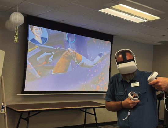 MATC Student Recruiting Coordinator, Michael Gustafson, using interactive vVR technology to simulate a knee surgery. Courtesy photo