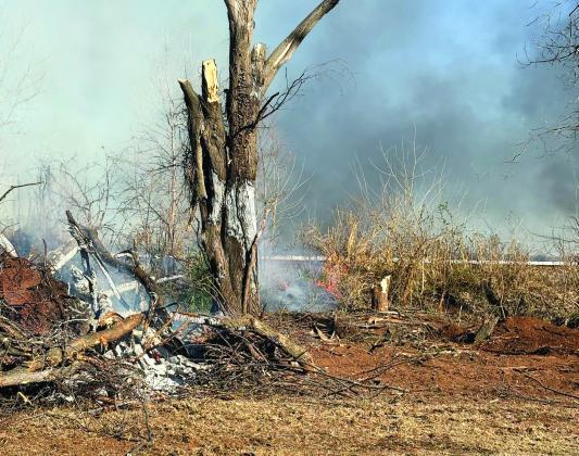A tree smolders during a prescribed burn at Wacker Park in Pauls Valley earlier this month. Dry conditions and increasing fire danger caused County Commissioners to issue a countywide burn ban Monday. News Star photo by Ezekiel Mackey