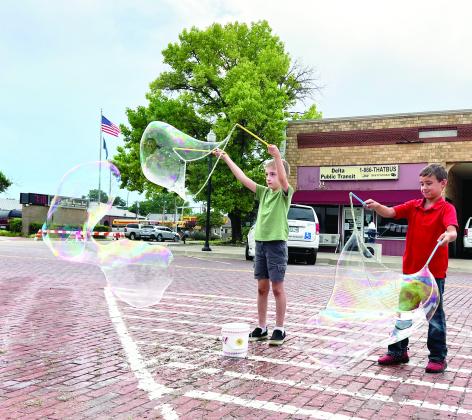 Children (and adults) attending the Fifth Friday Art Walk in downtown Pauls Valley June 30 had the opportunity to try their hand at making giant bubbles as part of the evening’s entertainment provided by Inspyral Circus Giant Bubbles. News Star photos by Suzanne Mackey