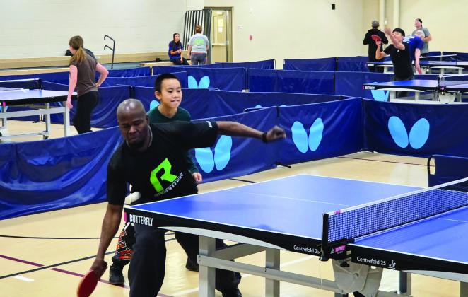 Winfred Addy (left) competed in table tennis at the 1996 Olympic Games. Saturday he teamed up with a student he coaches to compete at the Valley Paddle Battle at the Donald W. Reynolds Recreation Center. News Star photo by Jennifer Lindsey.