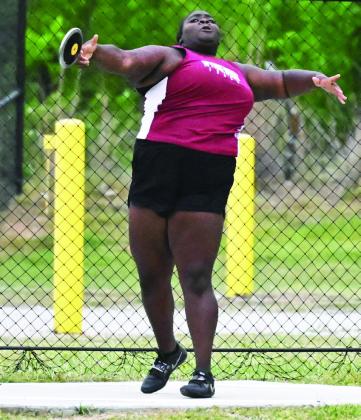 Wynnewood’s Annika Pittman throws a discus at the Wilson track meet last weekend. Pittman placed fourth in the discus. 