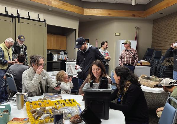 Geologists from the Oklahoma Geological Survey help identify rocks, minerals and fossils brought in during Saturday's "Geologist Office Hours on the Road" event.