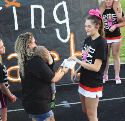 Lindsay cheer squad presents check to Largent family. Photo courtesy Sheryl Kochert