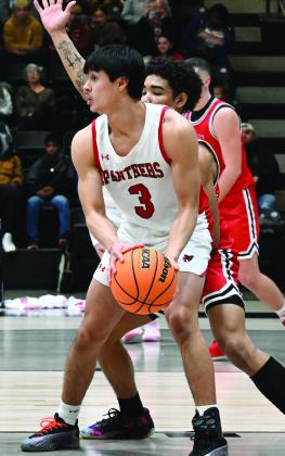 Panther senior Jorge Fabela tries to pass the ball during the Panthers’ district game against Sulphur Feb. 21. 