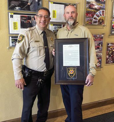 Garvin County Sheriff Jim Mullett presents a letter of appreciation to local businessman Richard Freeman for providing a facility for law enforcement agencies to use as a command center during a recent manhunt near Wynnewood. Photo Courtesy of GCSO.