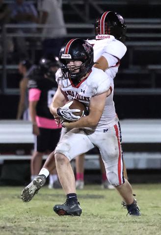 Pauls Valley running back Christian Stockman looks for a hole to open up along the line during the game at Lone Grove Oct. 9.  Photo by Mike Arie