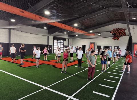 The Pride of Lindsay escapes the heat by practicing in the new Leopard Training Facility. The multipurpose building was built with funds from a $11,795,000 bond issue passed in August 2024. While the weight-training area is still incomplete, the turf area is already being utilized. Courtesy Photo