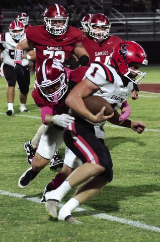 Wynnewood’s Braylon Pierce makes a hit on Stratford Joesph Smith during the Savages’ win at home Friday night. Photo by Mike Arie