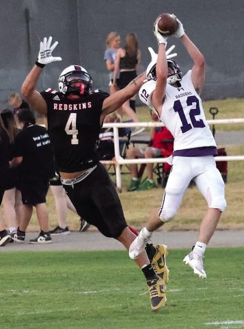 Elmore City-Pernell’s Jesse Cook goes up and intercepts a pass in front of Rush Springs’ Derrick Boyster during Friday’s 48-0 loss to the Redskins. Photo by Mike Arie