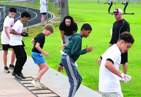 Young football players practice their skills at Baylor running back Caden Knighten’s first official football camp at the Wynnewood High School football field May 23. News Star photos by Don Coffey