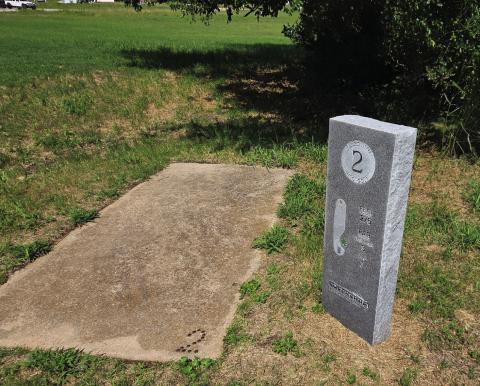 The tee at Hole 2 of the Flightline Golf Course includes a concrete pad and a granite marker specific to the hole. News Star photos by Jennifer Lindsey