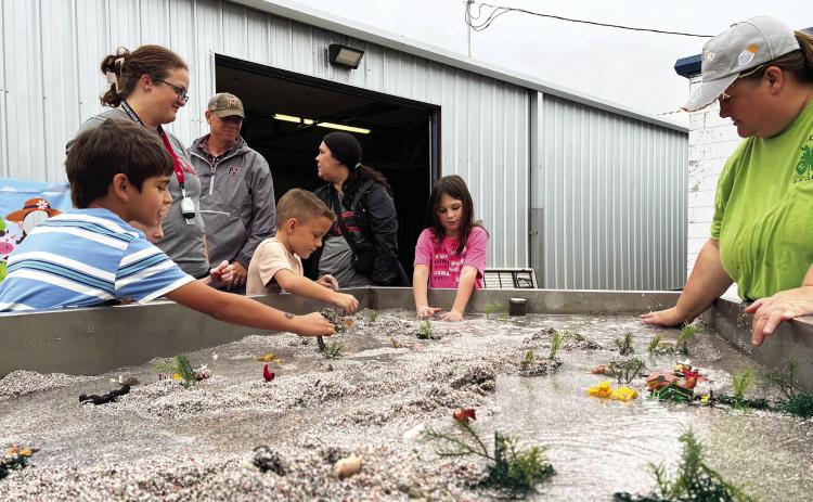 Kids Day at the 2025 Garvin County Free Fair Aug. 29 was all about hands-on learning. Here area school children learn how water flows over and around different types of terrain.