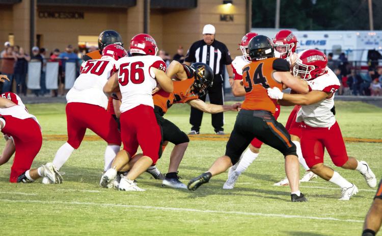 Lindsay's Priest Williams battles two of Purcell's offensive linemen to get to the Purcell quarterback. Lindsay won the battle against Purcell 12-7. News Star photo by Kristy Schrader