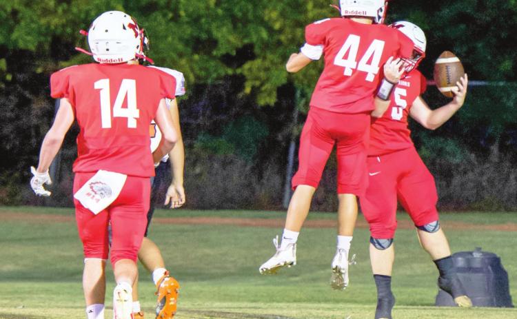 Bryce Shannon and Holden Tyler celebrate Nigel Reid's touchdown against Ryan last Thursday night. Photo by Kristy Schrader