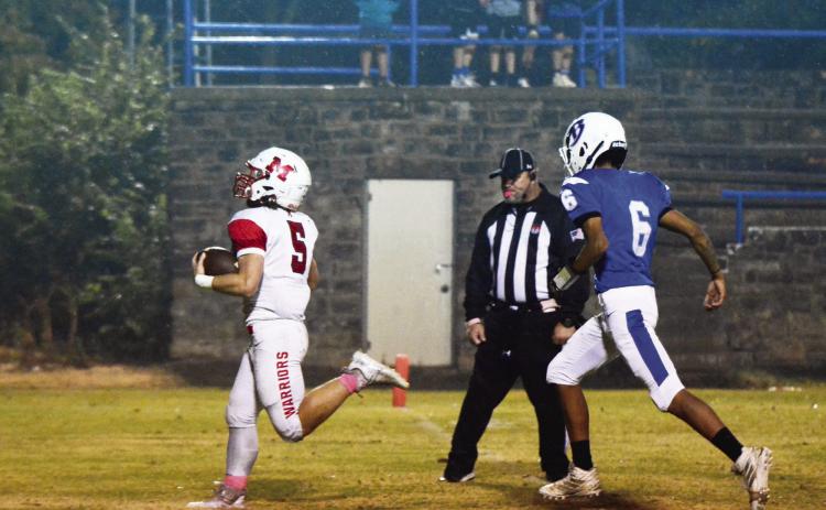 Maysville’s Nigel Reid runs for one of the two touchdowns he scored for the Warriors against Bowlegs last week. Photo courtesy of Denny Park