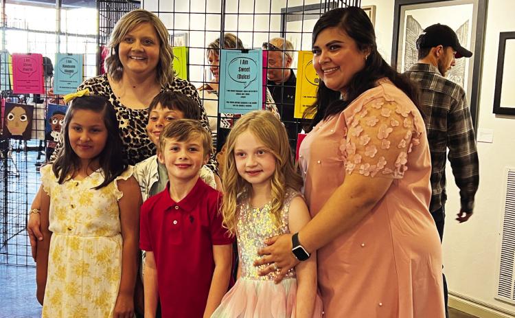 Whitebead first-grade teachers Erica Shippey (back left) and Isamara Prieto (far right) with several of the student artists who showed their self-portraits during Monday night's art show at The Vault Art Place and Gathering Space in downtown Pauls Valley. News Star photo by Suzanne Mackey