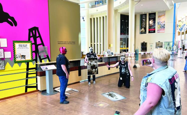 A new photo exhibit at the Oklahoma History Center pays homage to Oklahoma’s ties to professional wrestling. Staff at the History Center had fun dressing up as professional wrestlers during Tuesday’s opening event for the new exhibit. Courtesy Photo