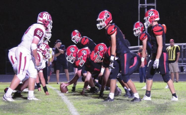 The Savages' defense tries to stop the Bulldogs from scoring. Photo by Chris Mackey